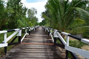 Wooden bridge to the beach in Sematan with Backyard Tour Malaysia