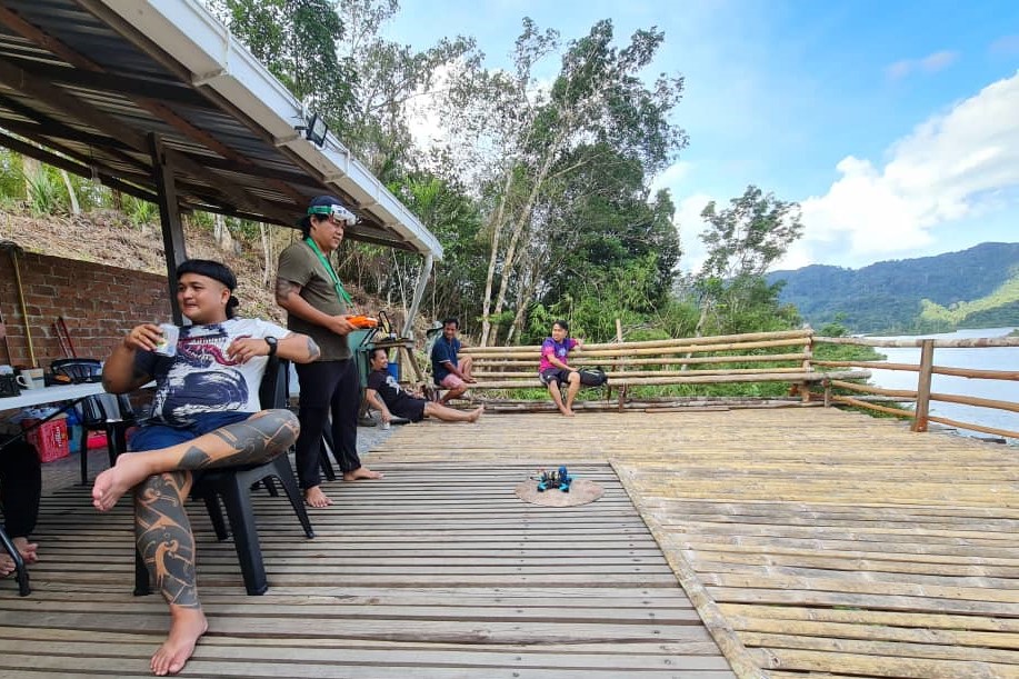 Relax by the 'tanju' or bamboo platform of Wes Kandung Homestay viewing across the dam area